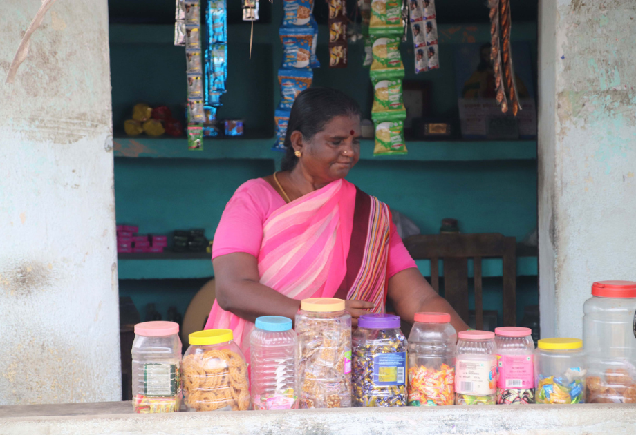 Indian woman in pink sari store front