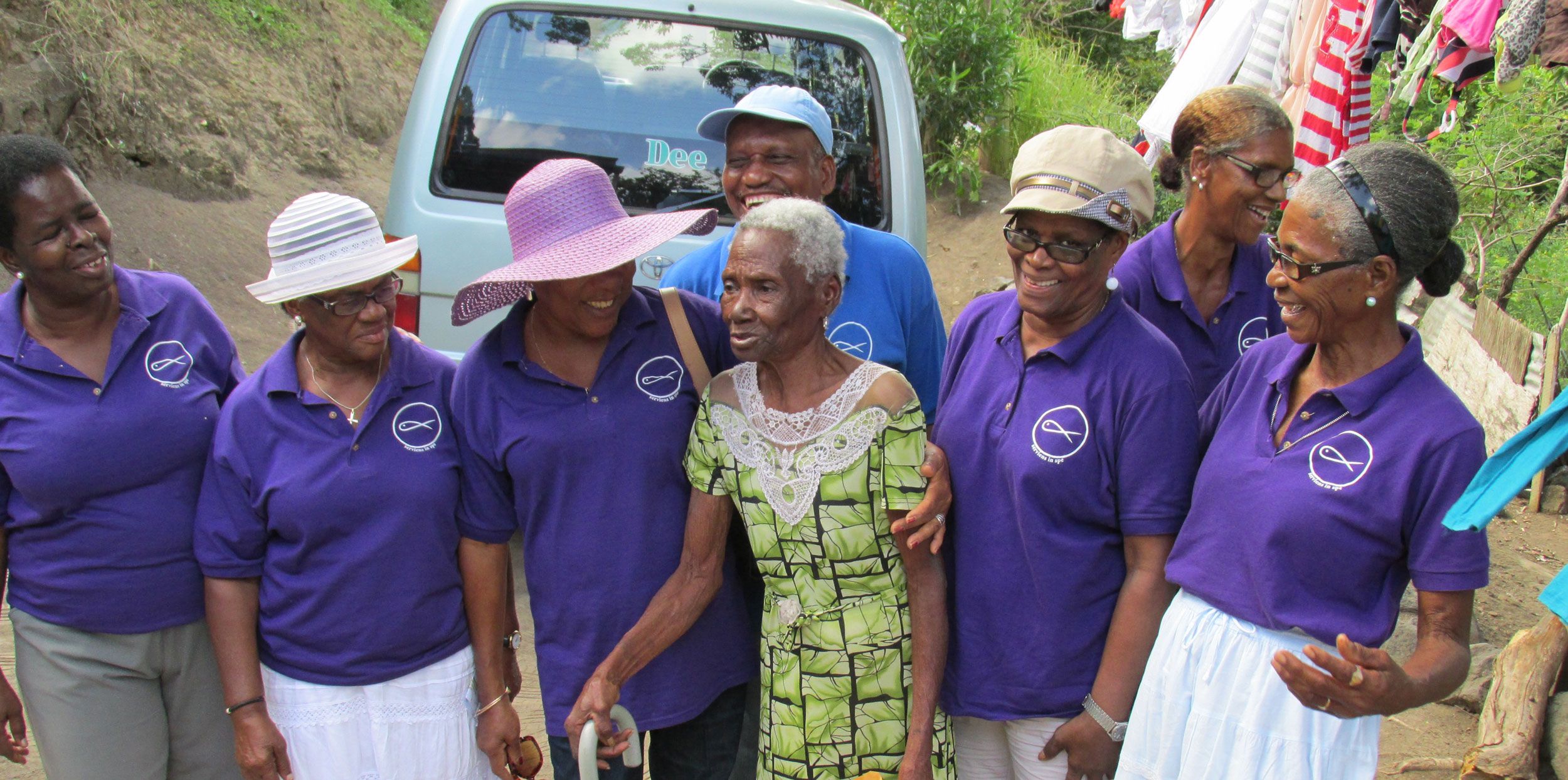 Grenada locals in blue polo shirts smiling