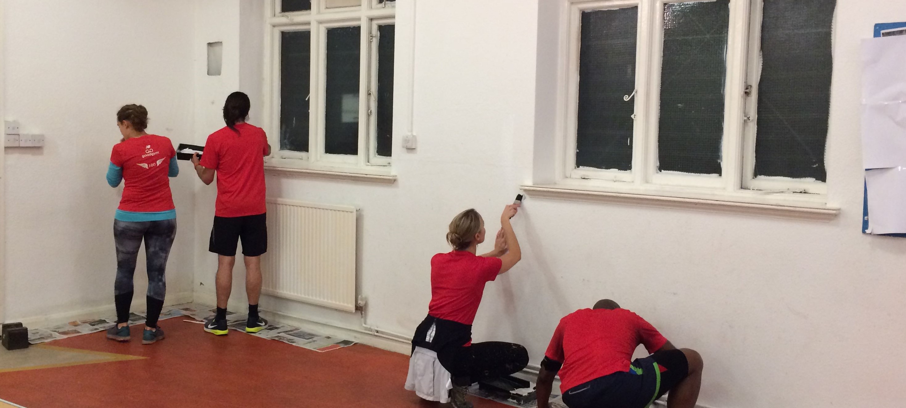volunteers red shirts painting hall