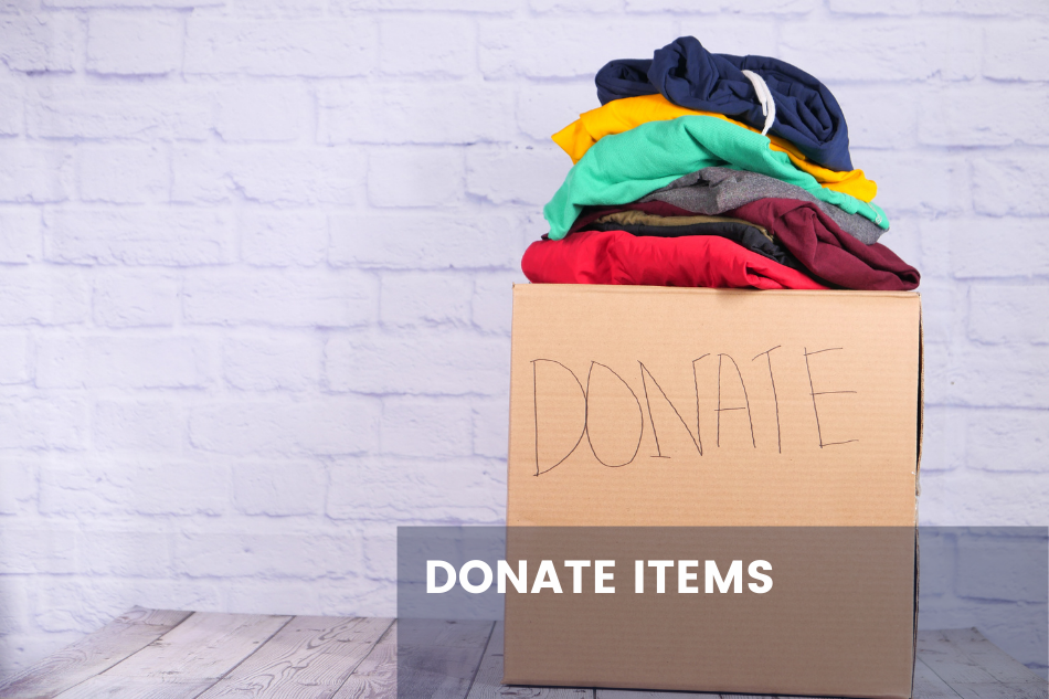 a box of clothes with donate written on it