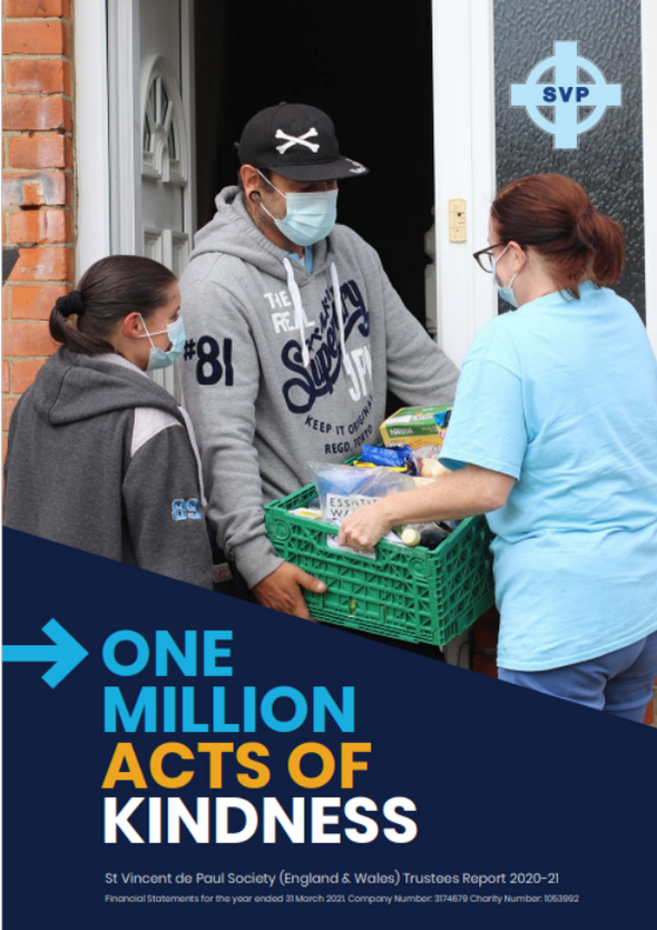Annual report cover of a man with a black cap and face mask gives out food from a box with two women volunteers