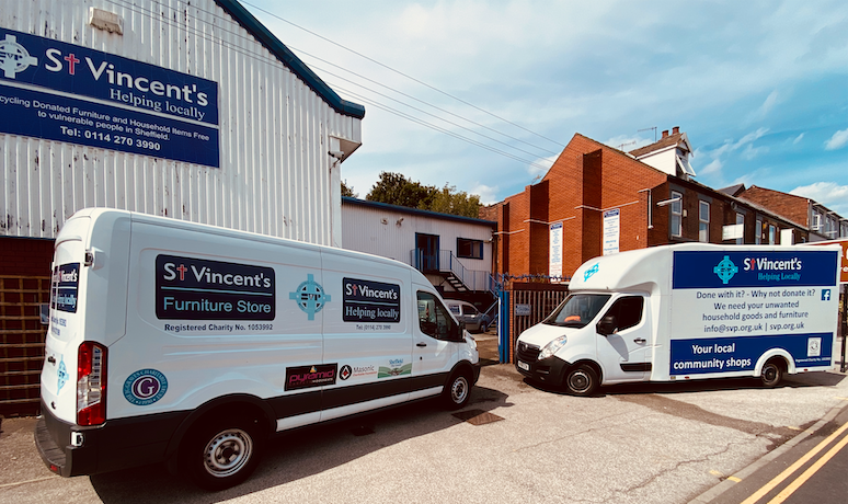 Two white St Vincent's furniture vans parked outside St Vincent's Sheffield