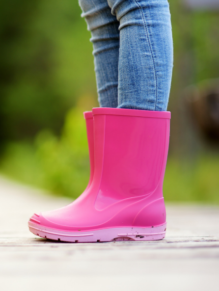 Bright pink wellington boots at children's camp