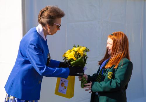 Amelie Merrick of St Joseph’s Roman Catholic School Mini Vinnies presents a bouquet of flowers to HRH the Princess Royal